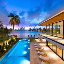 Modern Biscayne Bay pool villa at twilight with Miami skyline